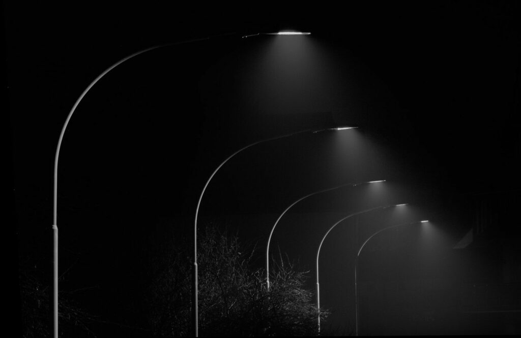 a black and white photo of a street light