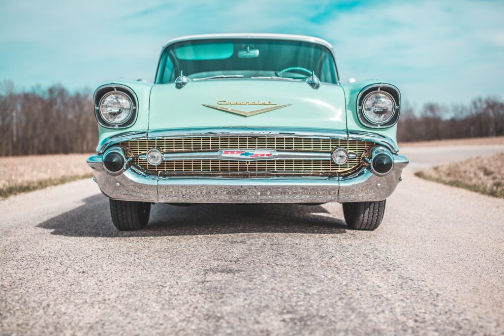 low-angle photo of classic teal Chevrolet car